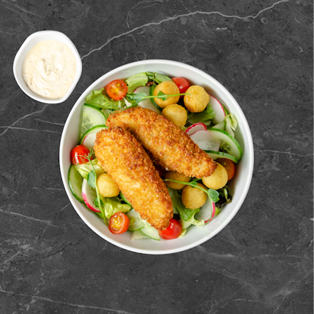 Salad with crispy chicken fingers and fried potato croquettes