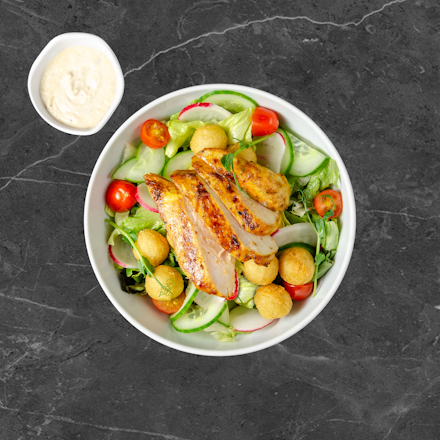 Salad with grilled chicken and fried potato croquettes