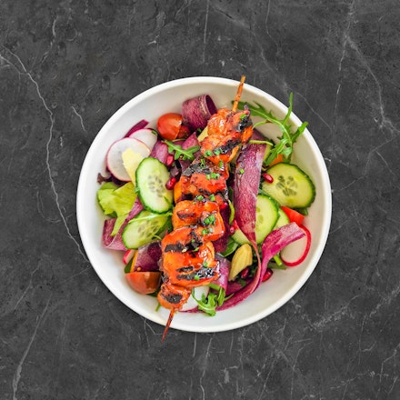 Green salad with Teriyaki chicken skewer
