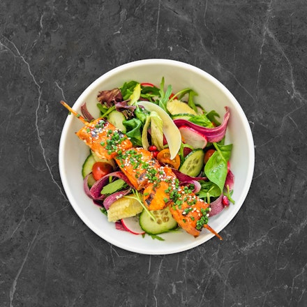 Green salad with salmon skewer
